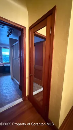 a view of empty room with wooden floor