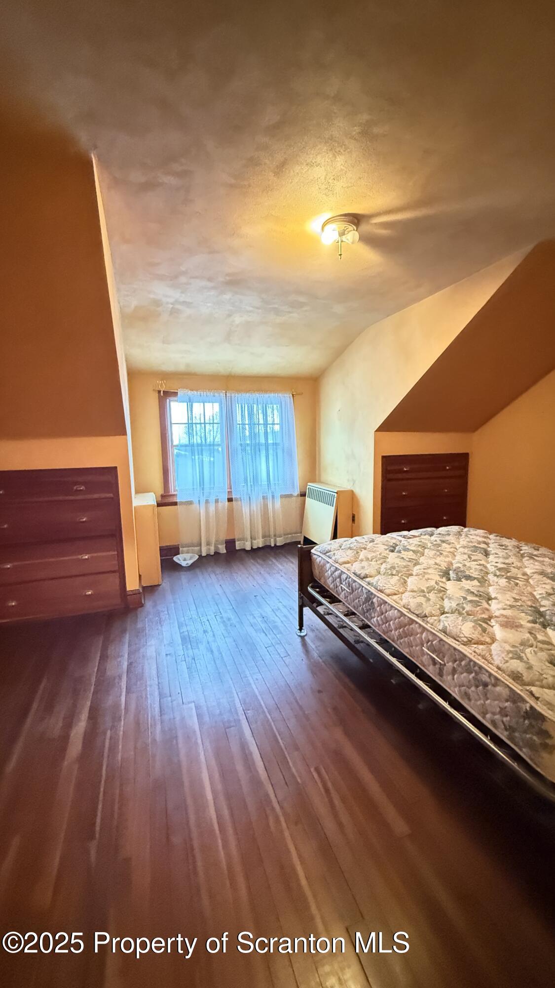 220 Hickory Ridge Road Carbondale, PA 18407 - Photo 43 of 51 a bedroom with a bed and wooden floor