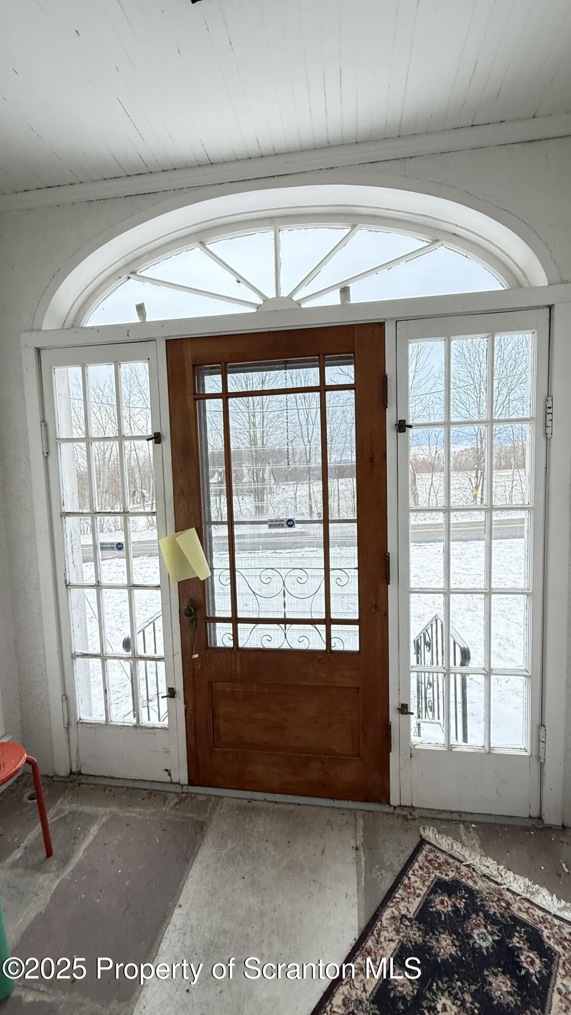 220 Hickory Ridge Road Carbondale, PA 18407 - Photo 7 of 51 a view of an empty room with a fireplace and large windows