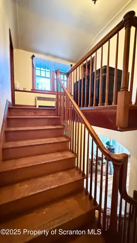a view of a room with wooden floor and window