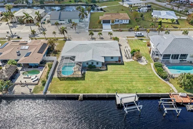 an aerial view of a house with swimming pool and ocean view