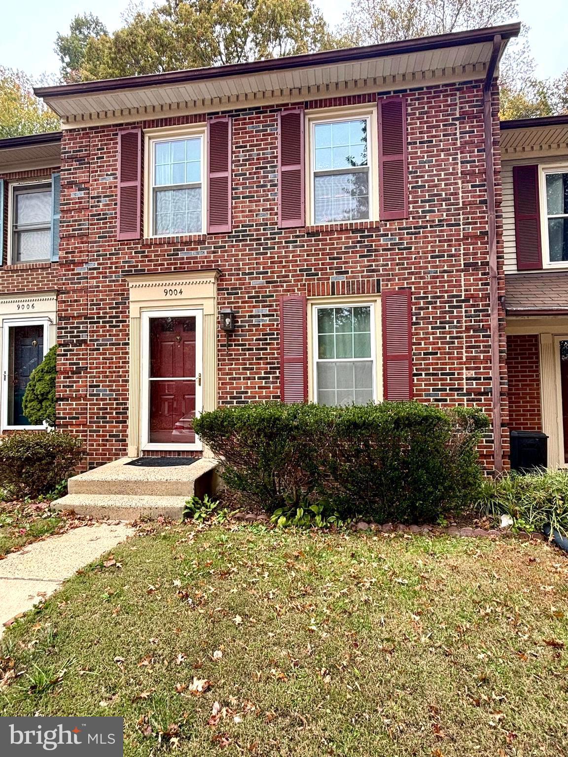 9004 Mulvaney Court Springfield, VA 22152 - Photo 1 of 23 a view of a brick house with a yard and plants