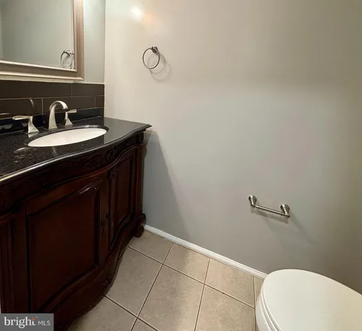 a bathroom with a sink a toilet and vanity