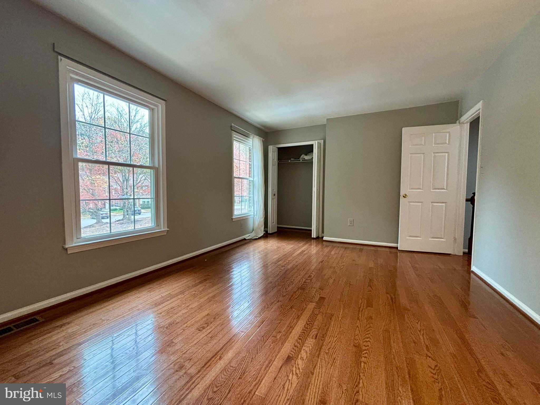 9004 Mulvaney Court Springfield, VA 22152 - Photo 14 of 23 a view of an empty room with wooden floor and a window