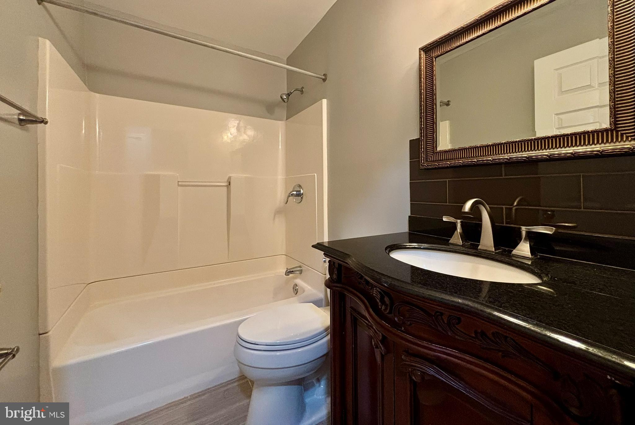9004 Mulvaney Court Springfield, VA 22152 - Photo 16 of 23 a bathroom with a sink a toilet and shower