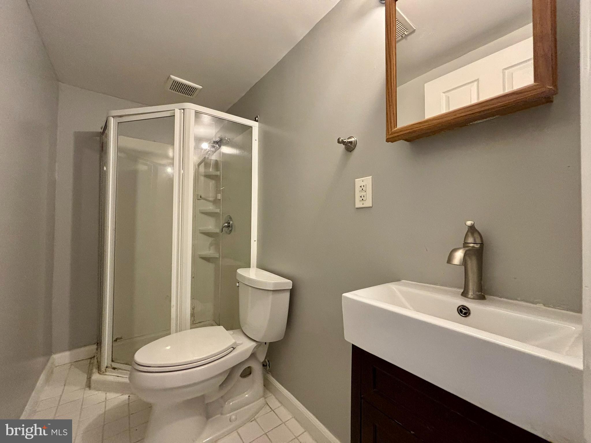 9004 Mulvaney Court Springfield, VA 22152 - Photo 22 of 23 a bathroom with a toilet a sink and mirror