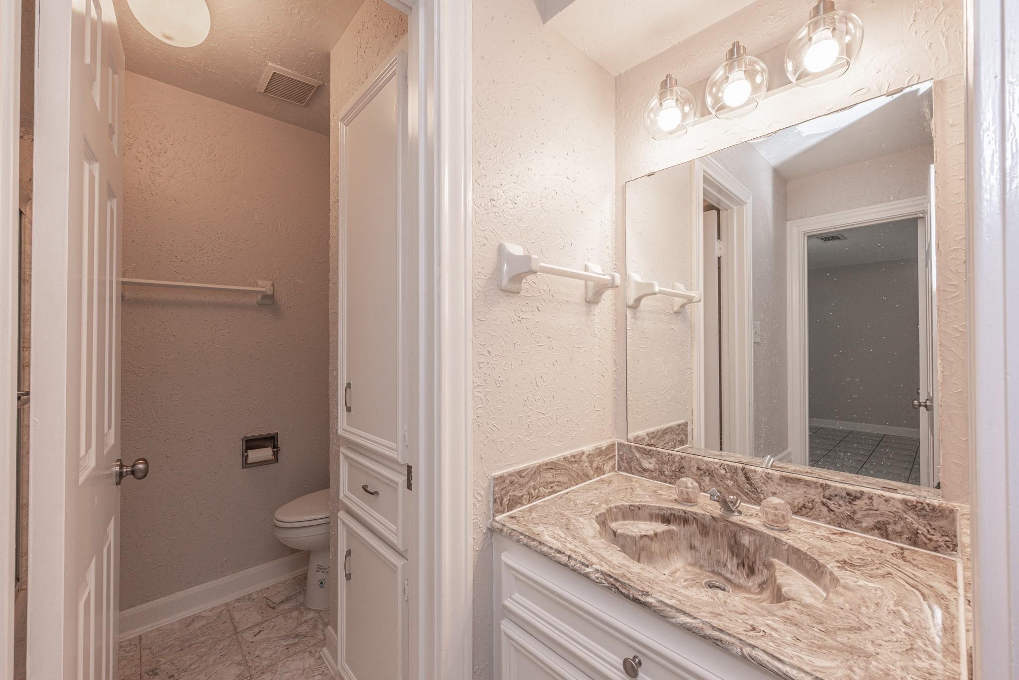 8019 Beaufort Drive Spring, TX 77379 - Photo 22 of 47 a bathroom with a granite countertop sink toilet and shower
