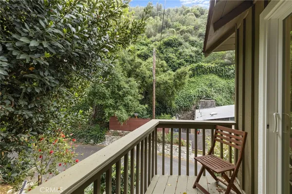 a view of a balcony with wooden fence and floor