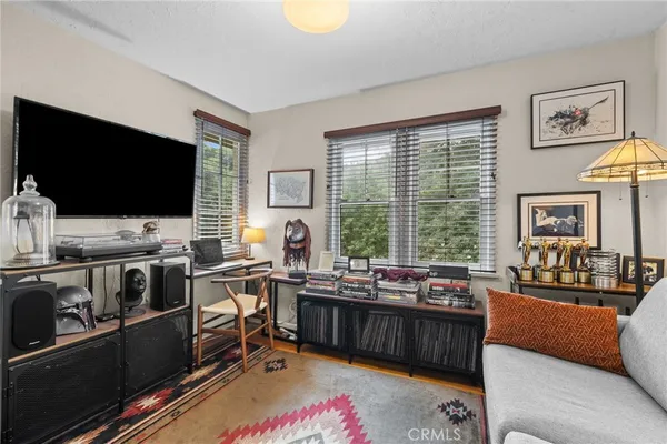 a view of a livingroom with workspace and a couch