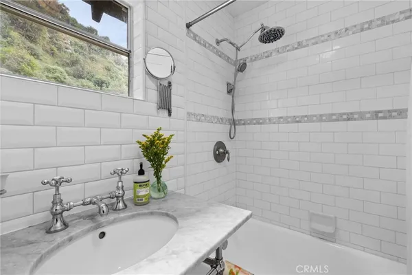 a bathroom with a sink a bathtub and a shower