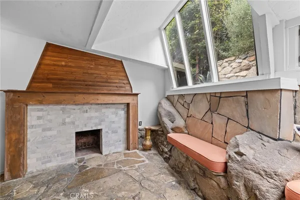 a bedroom with furniture and a fireplace