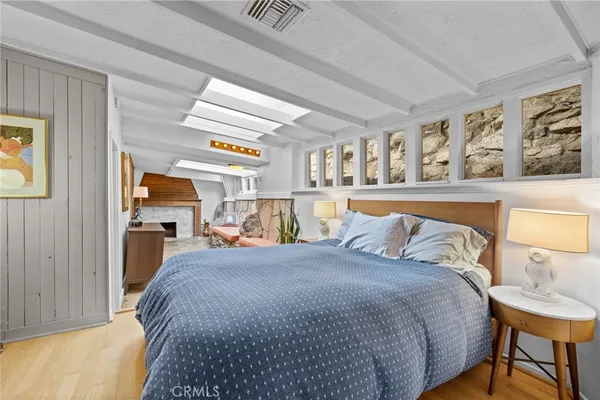 a bedroom with a bed and flat screen tv