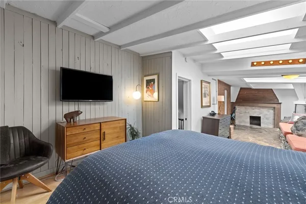 a bedroom with a bed and a flat screen television