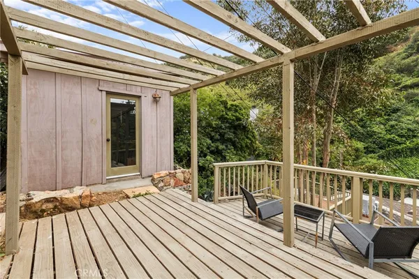 a view of balcony with wooden floor and outdoor seating