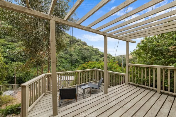a view of balcony with wooden floor and outdoor seating