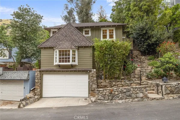 a front view of a house with a garden