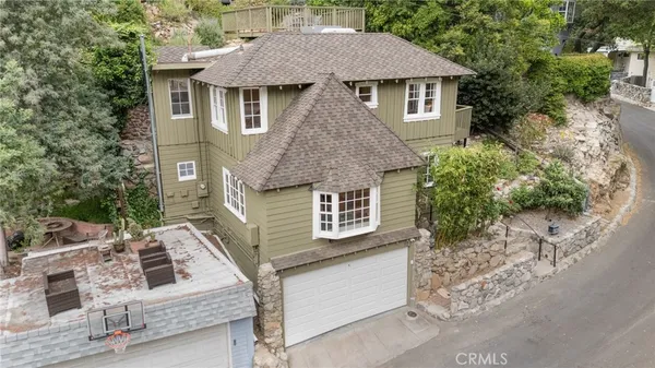an aerial view of a house with a yard and outdoor seating