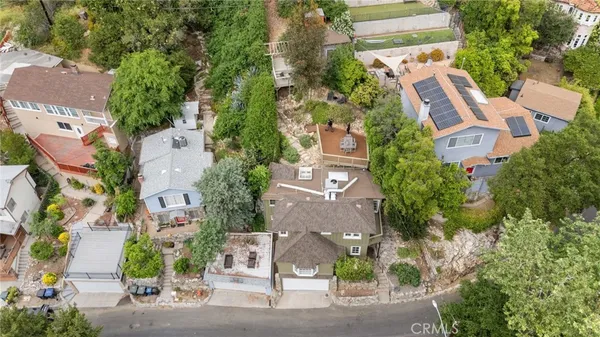 an aerial view of residential house with outdoor space and swimming pool