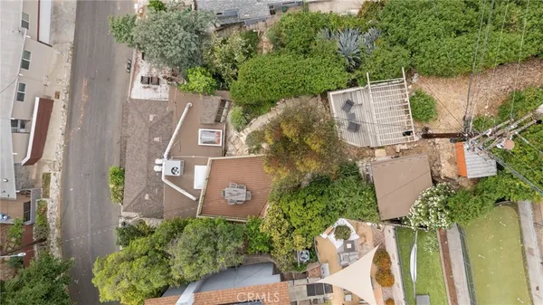 an aerial view of houses covered in trees