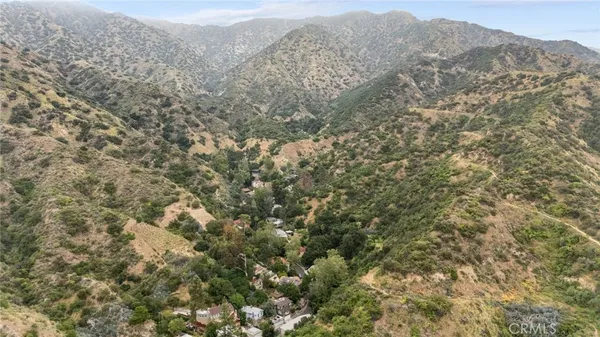 a view of a mountain range with lush green forest