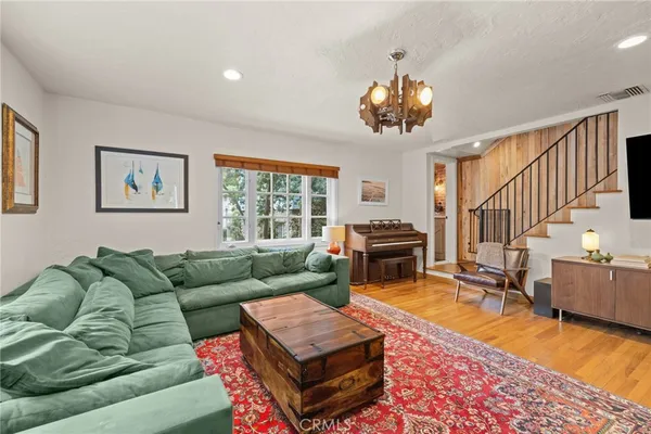 a living room with furniture a rug and a window