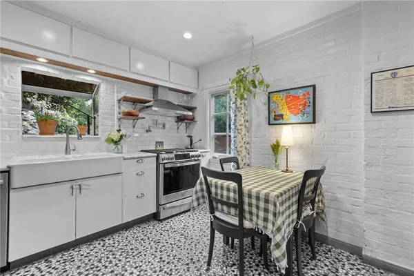 a kitchen with stainless steel appliances kitchen island granite countertop a sink and a refrigerator