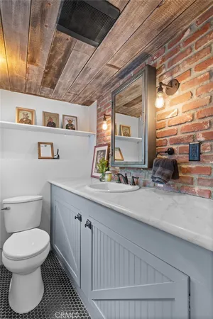 a bathroom with a toilet a sink and mirror
