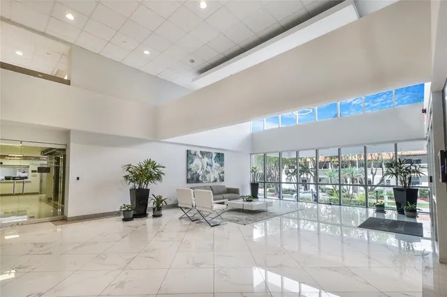 a living room with furniture a ceiling fan and a window