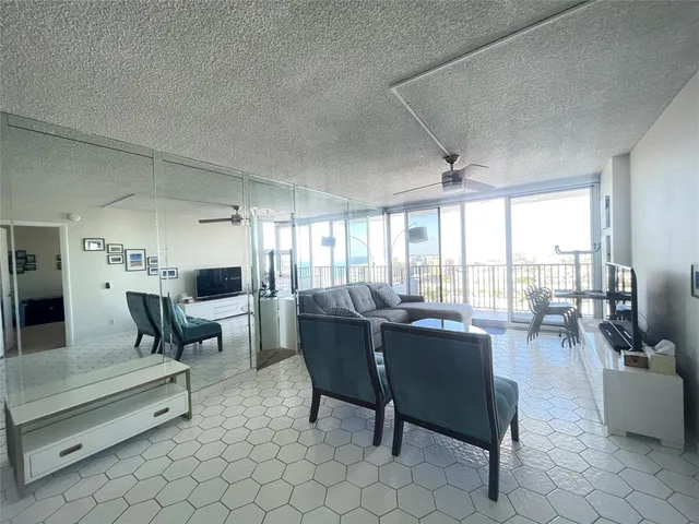 a living room with a flat screen tv and a rug