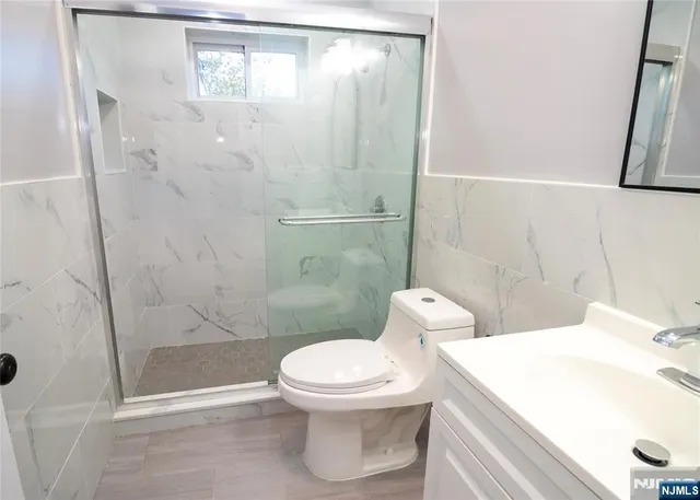 a white toilet sitting next to a bath tub