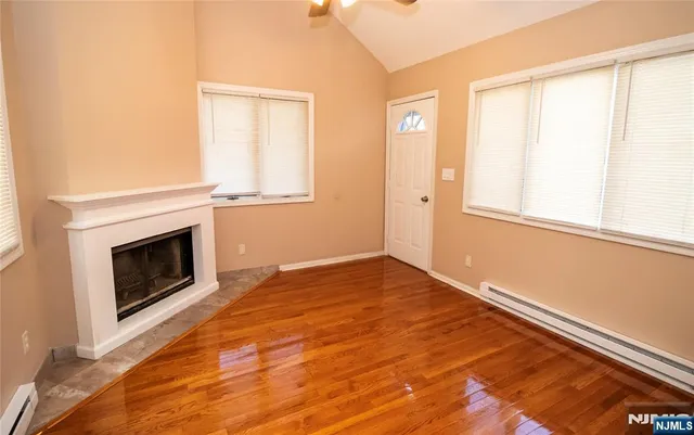 a view of empty room with window and fireplace