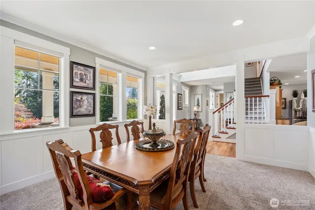 a view of a dining room with furniture large windows and wooden floor