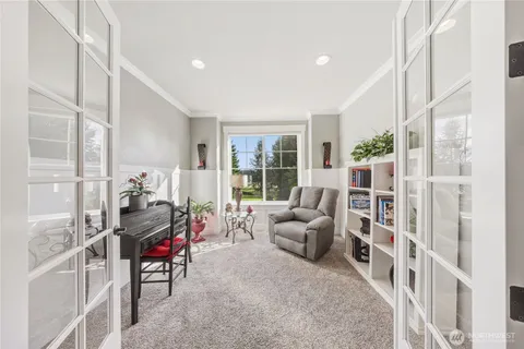 a living room with furniture and a floor to ceiling window