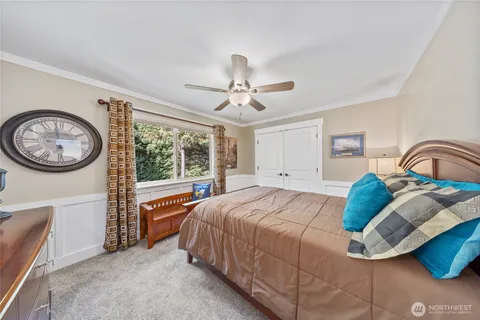 a bedroom with a bed and a large window