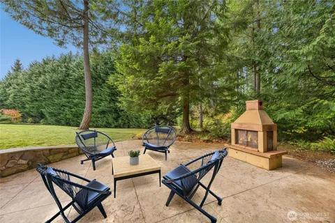 a view of a patio with a table and chairs under an umbrella