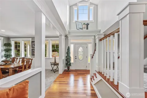a view of an entryway with wooden floor and door