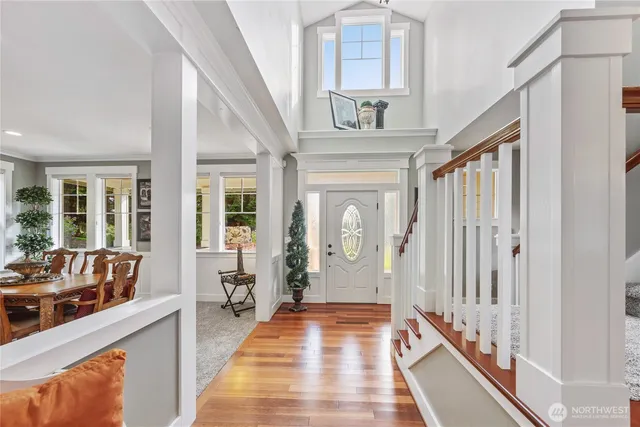 a view of an entryway with wooden floor and door