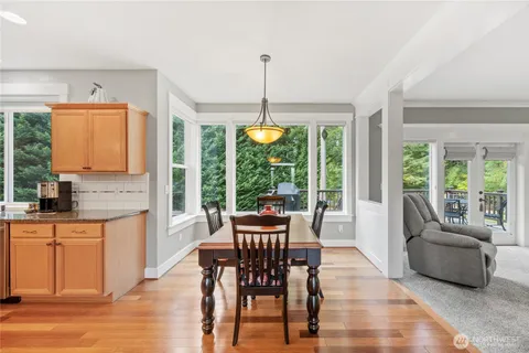 a dining room with furniture window and wooden floor