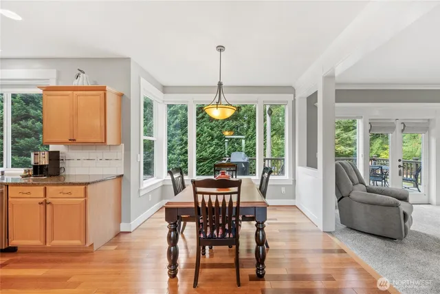 a dining room with furniture window and wooden floor