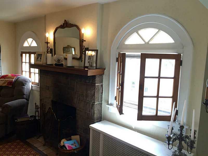 109 Braddock Road Forest Hills, PA 15221 - Photo 7 of 25 Living Room. The stone fireplace is flanked by lovely French windows