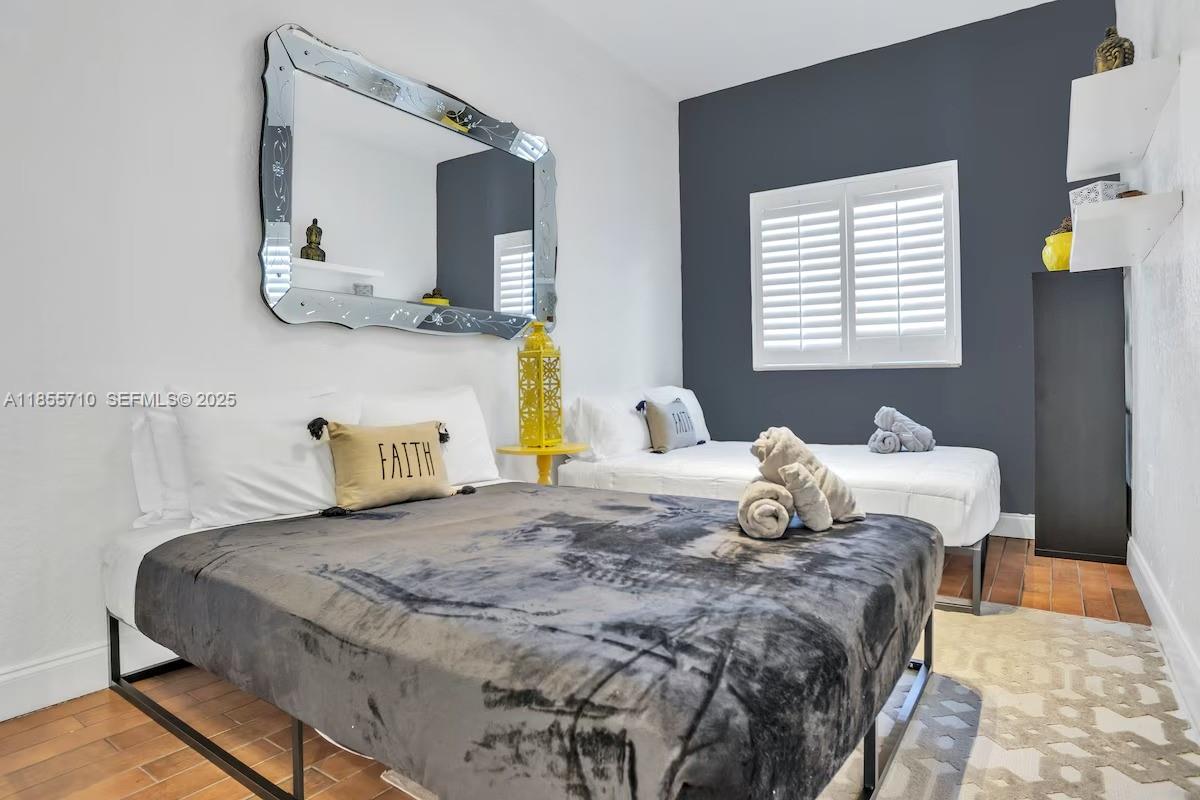 205 North 31st Avenue, Unit 1 Hollywood, FL 33021 - Photo 11 of 42 a bedroom with a bed and a window