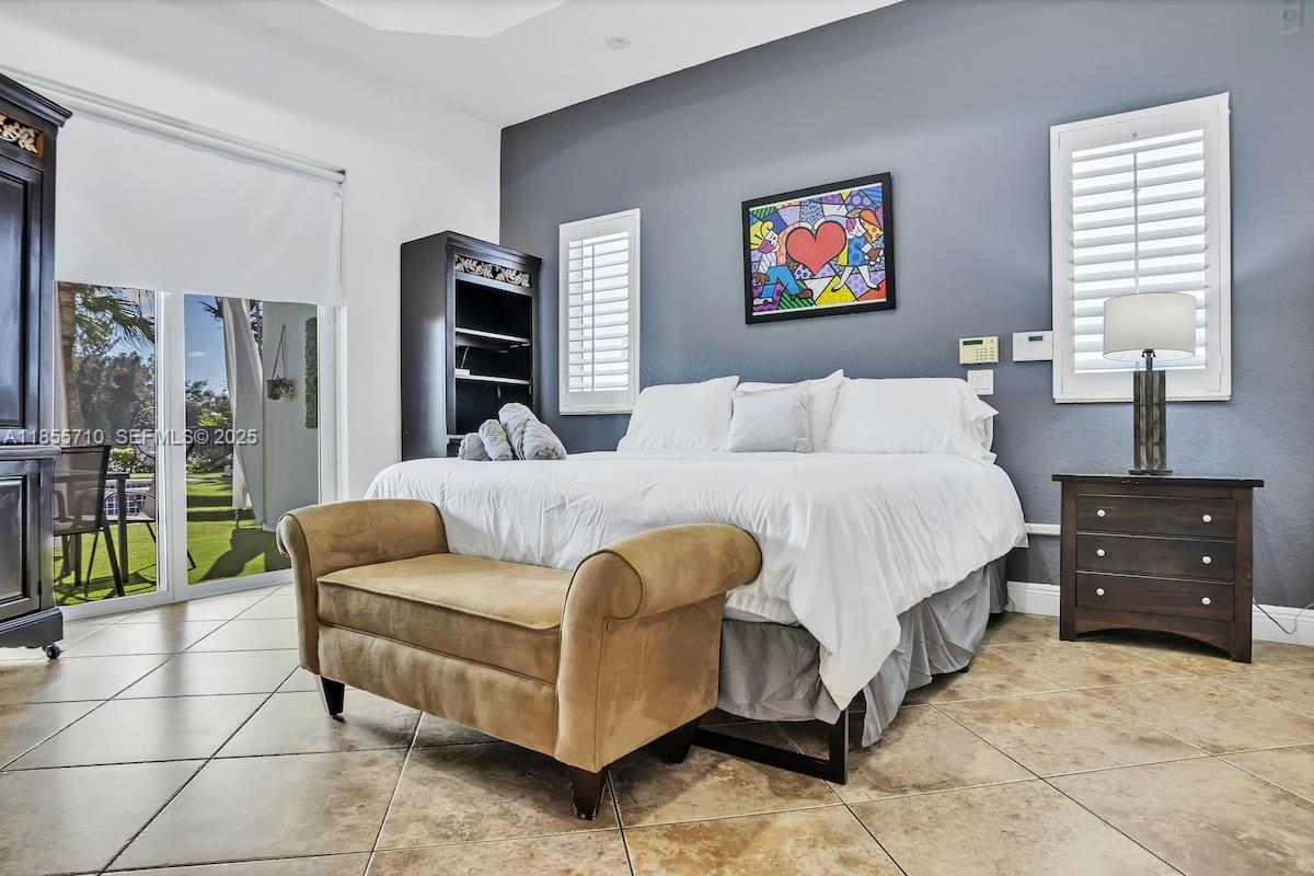 205 North 31st Avenue, Unit 1 Hollywood, FL 33021 - Photo 15 of 42 a living room with furniture a flat screen tv and a walk in closet