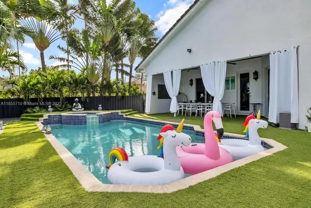 a bedroom with two beds and a large window