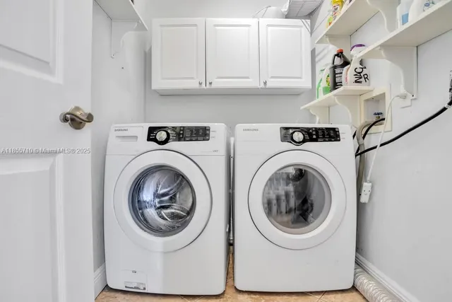 a view of a house with swimming pool lawn chairs and a yard