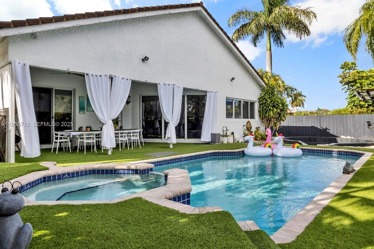 205 North 31st Avenue, Unit 1 Hollywood, FL 33021 - Photo 23 of 42 a view of a house with swimming pool lawn chairs and a yard