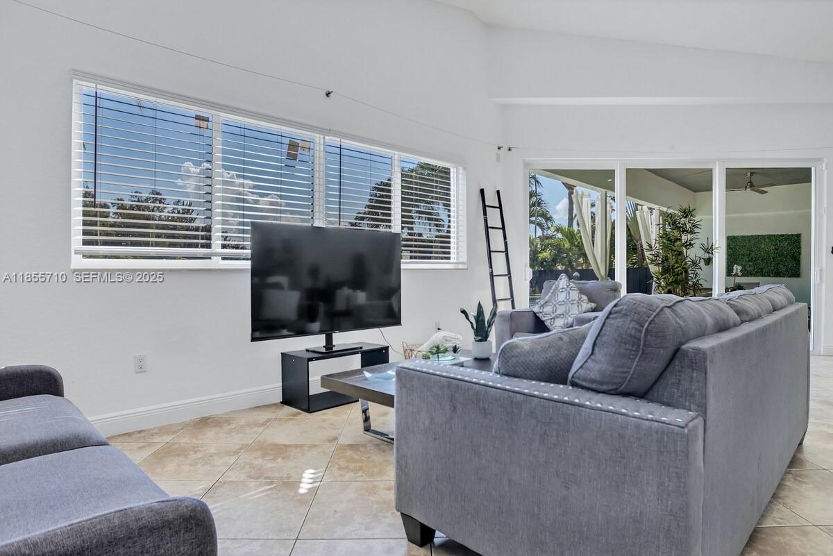 205 North 31st Avenue, Unit 1 Hollywood, FL 33021 - Photo 24 of 42 a living room with furniture and a flat screen tv
