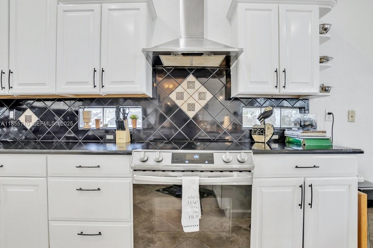 205 North 31st Avenue, Unit 1 Hollywood, FL 33021 - Photo 26 of 42 a kitchen with white cabinets and white appliances