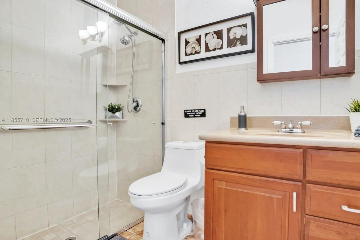 205 North 31st Avenue, Unit 1 Hollywood, FL 33021 - Photo 27 of 42 a bathroom with a sink a toilet and shower