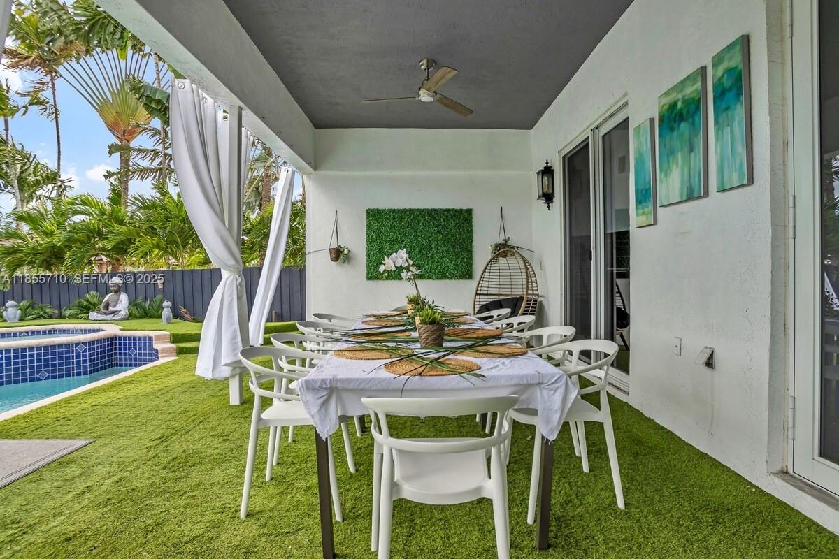205 North 31st Avenue, Unit 1 Hollywood, FL 33021 - Photo 28 of 42 a view of an outside dining space with furniture