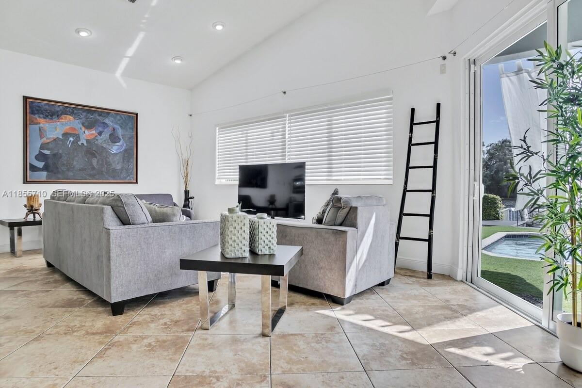 205 North 31st Avenue, Unit 1 Hollywood, FL 33021 - Photo 29 of 42 a living room with furniture and a flat screen tv